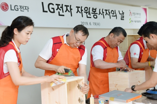 조성진 LG전자 대표이사 CEO 부회장(왼쪽 두 번째), 배상호 노조위원장(왼쪽 세 번째)이 재활원에 전달할 가구를 만들고 있다.(사진=LG전자)