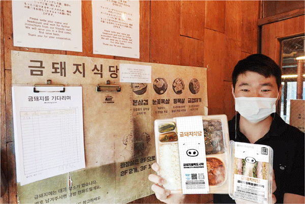 서울 중구 신당동 금돼지식당 앞에서 박세영 대표가 GS25와 협업한 상품을 들어 보이고 있다. (사진=GS리테일) 