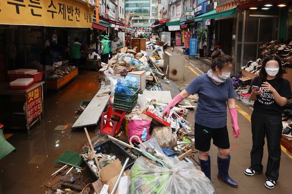 집중호우로 피해를 입은 서울 동작구 남성사계시장 상인들이 침수된 물품들을 정리하고 있다. (사진=연합뉴스)