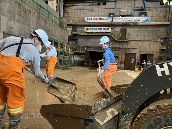 진흙을 퍼내고 있는 포항제철소 직원들. (사진=연합뉴스)
